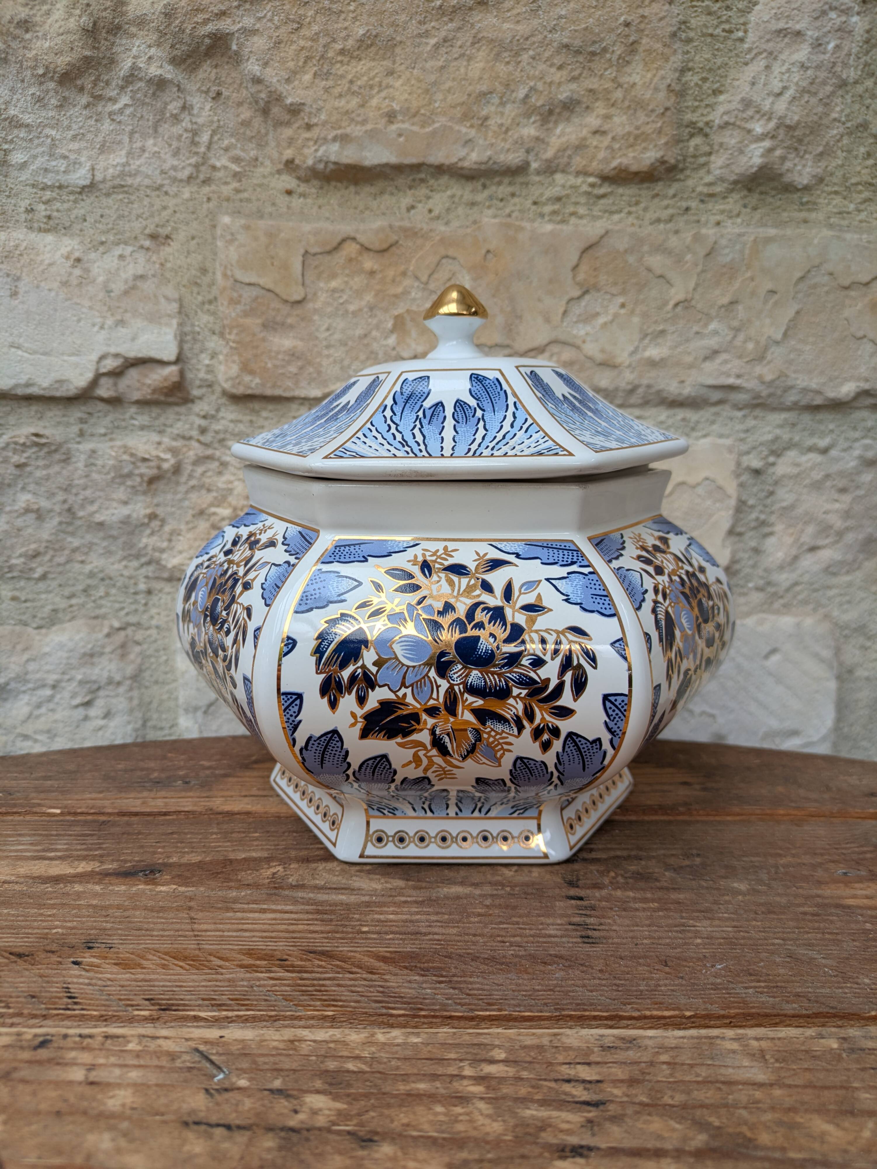 Decorative pot jar with a lid featuring a blue floral pattern and gilding.