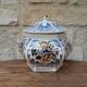 Decorative pot jar with a lid featuring a blue floral pattern and gilding.