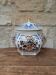 Decorative pot jar with a lid featuring a blue floral pattern and gilding.