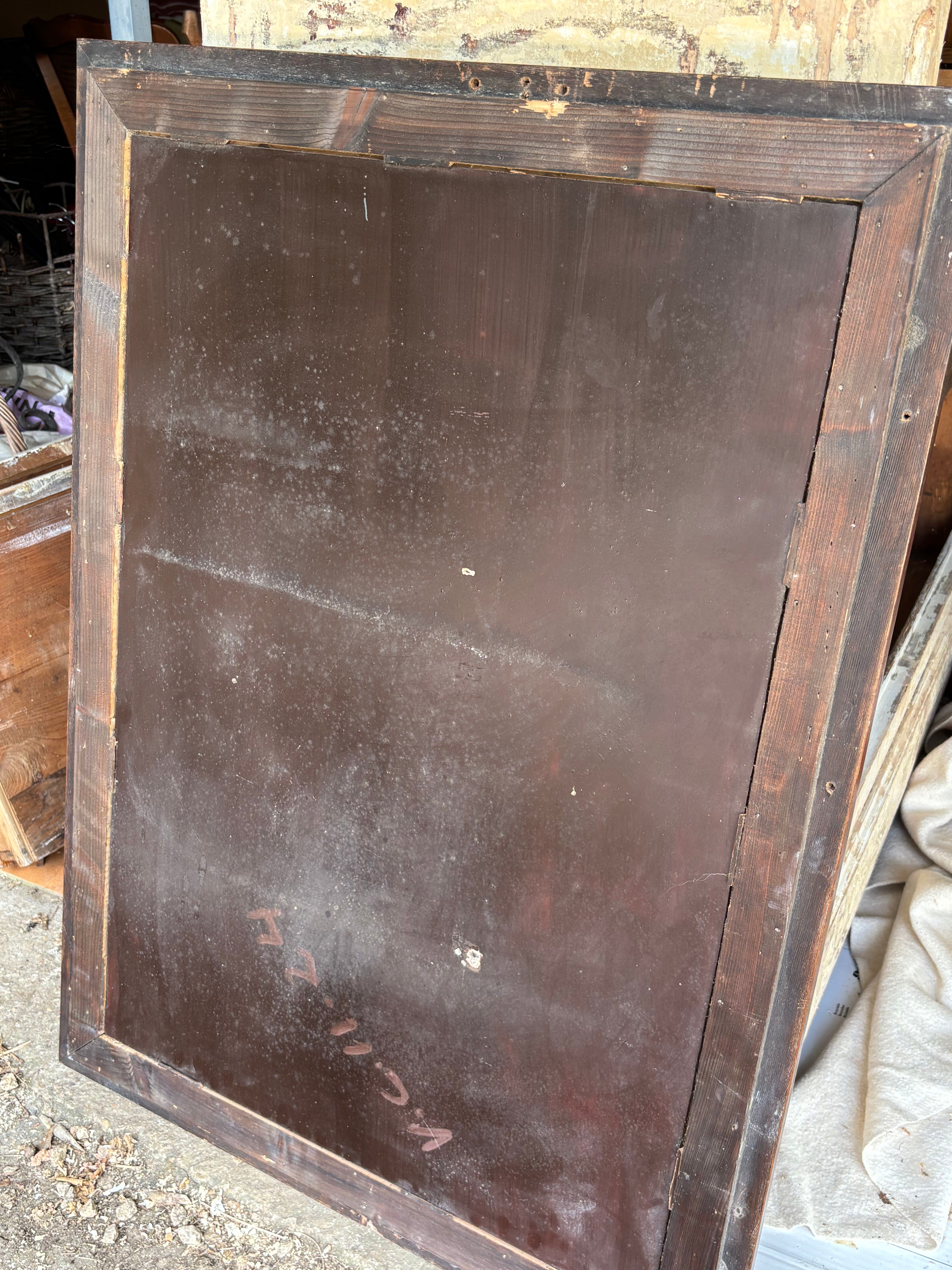 Large wall mirror with an elegant wooden frame.