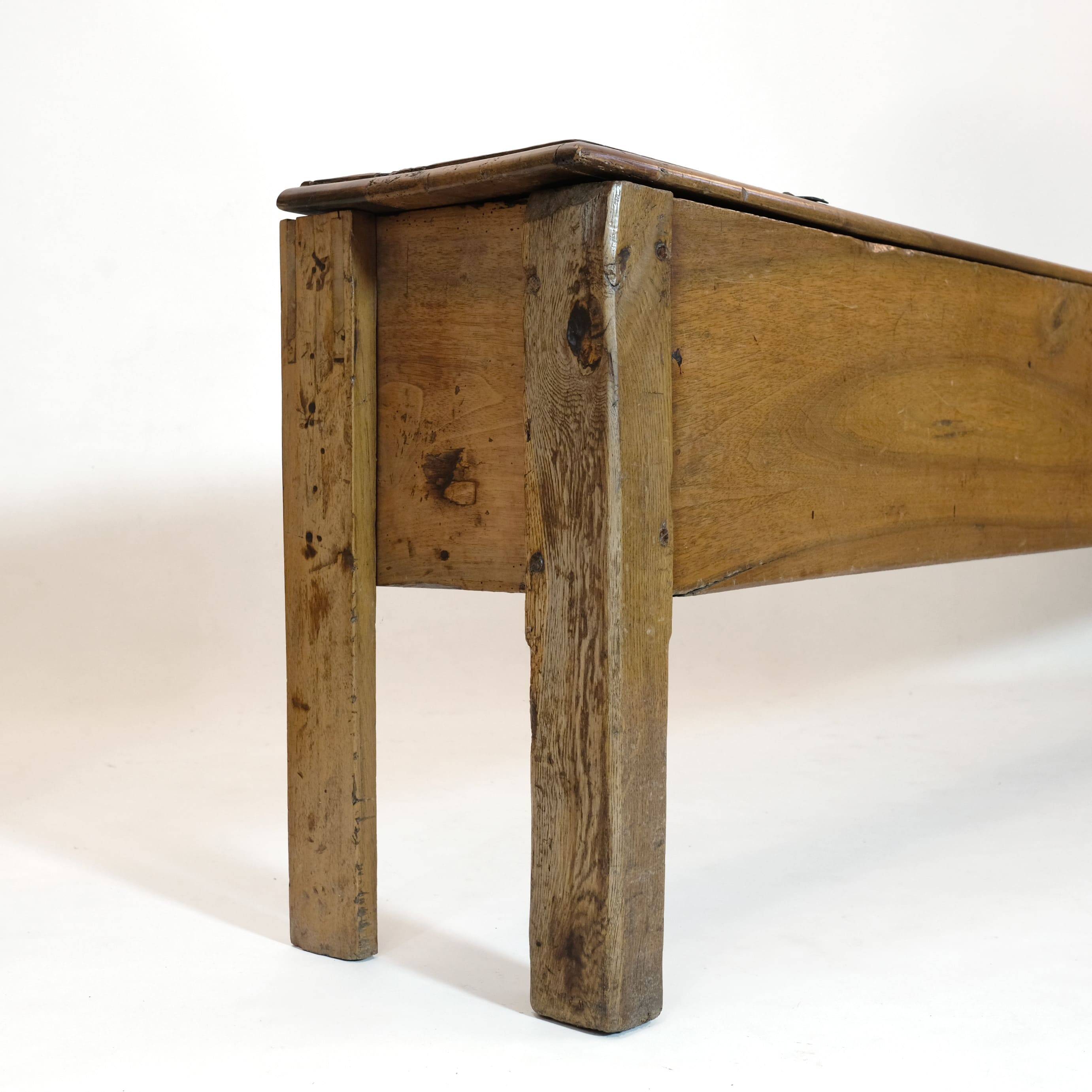 Long walnut grain chest forming a bench, 220cm.