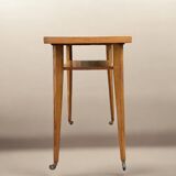 Varnished wooden trolley on wheels