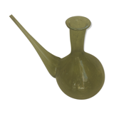 Green transparent glass bottle. Long-beaked biot.