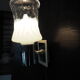 Transparent and white glass torch-type wall light.