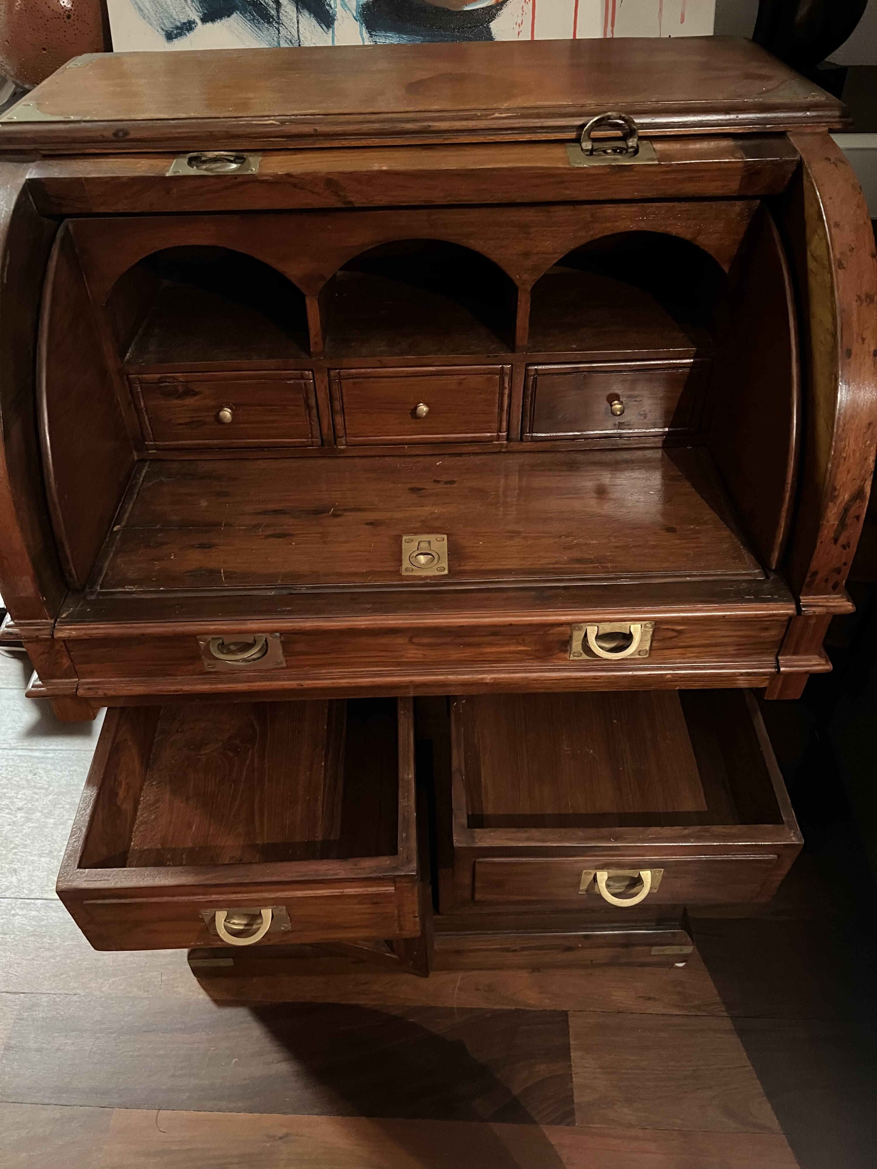 Antique solid wood secretary with a drop-down cylinder compartment.
