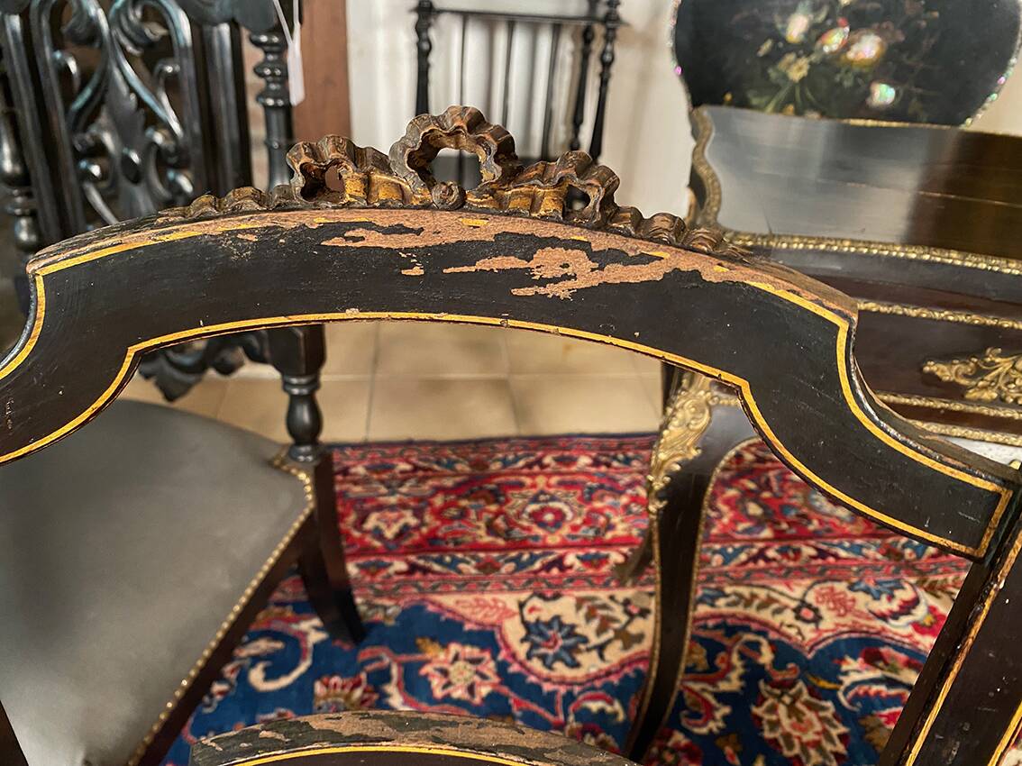 Set of four Napoleon III chairs in black lacquered wood with gold highlights.