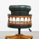 Classic green leather Chesterfield office chair on wheels.