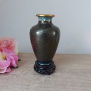 Small black cloisonné vase decorated with yellow and pink cherry blossoms, vase on wooden base