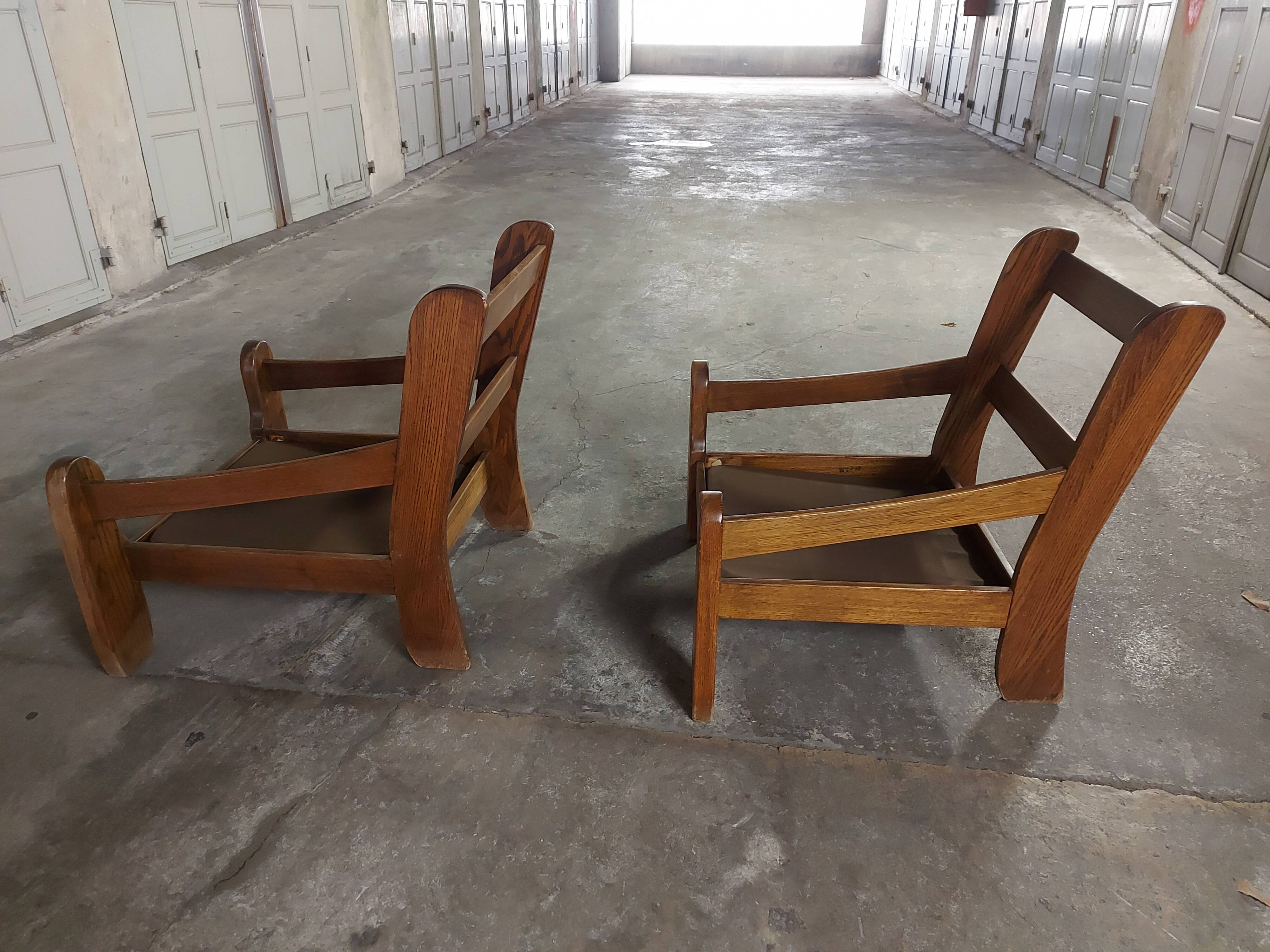 Armchairs in leather and vintage wood 70's