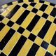 Round coffee table in yellow and black zellige, Moroccan graphic pattern.