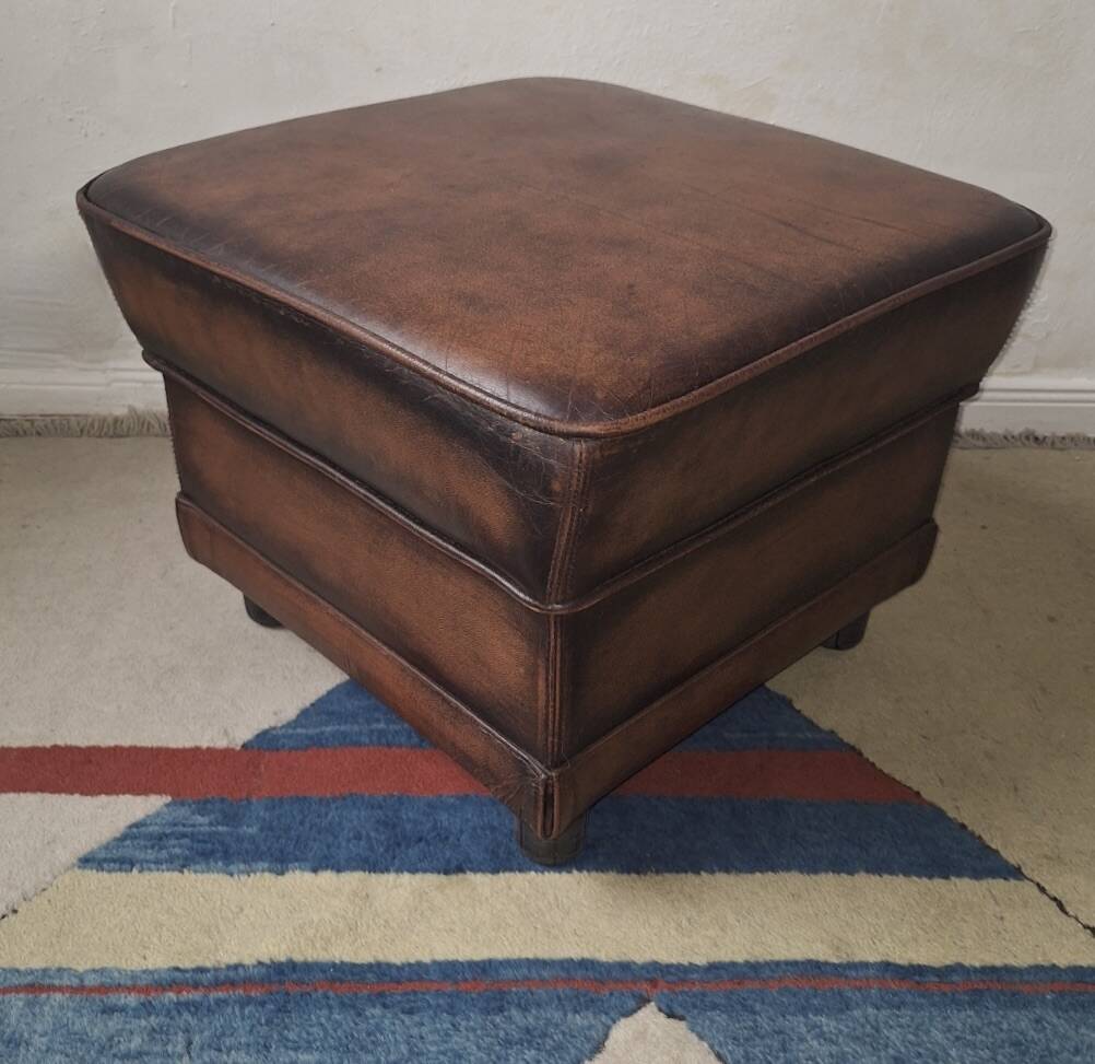 Vintage ottoman / pouffe in chestnut brown leather