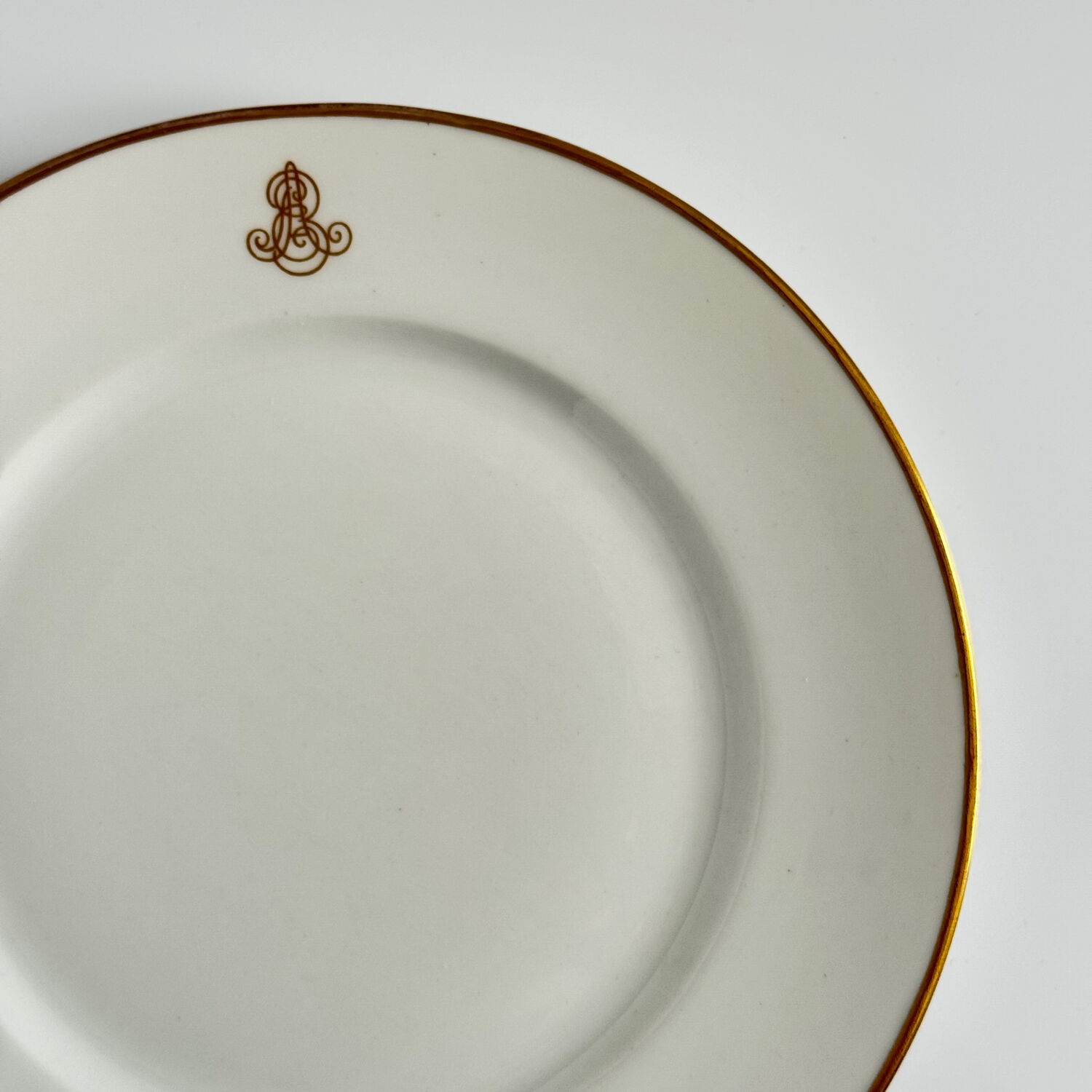 Set of monogrammed plates with gilt edges | E. Bourgeois | Late 19th century