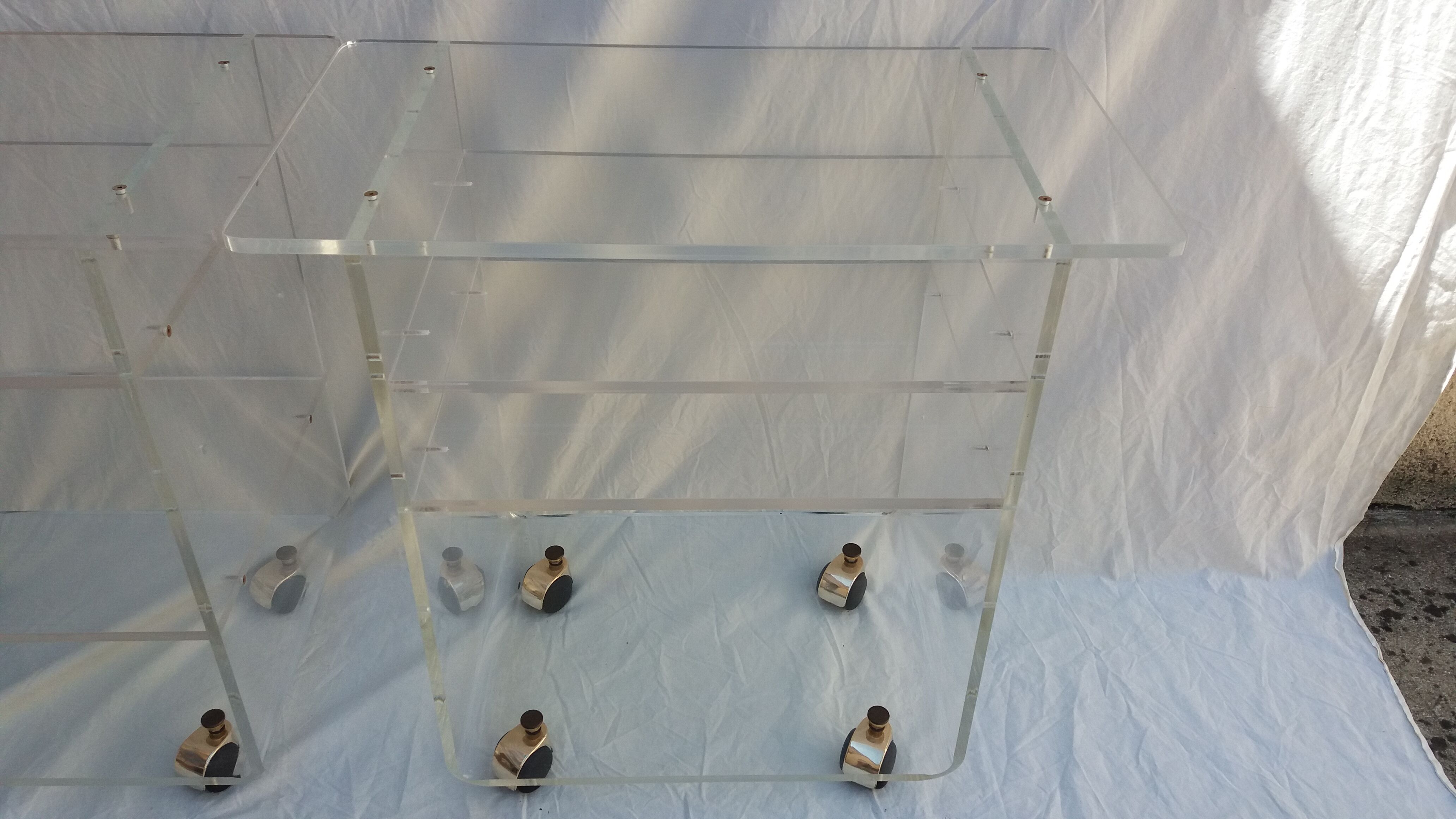 Pair of Plexiglas services branded "Les Invisibles du Marais"