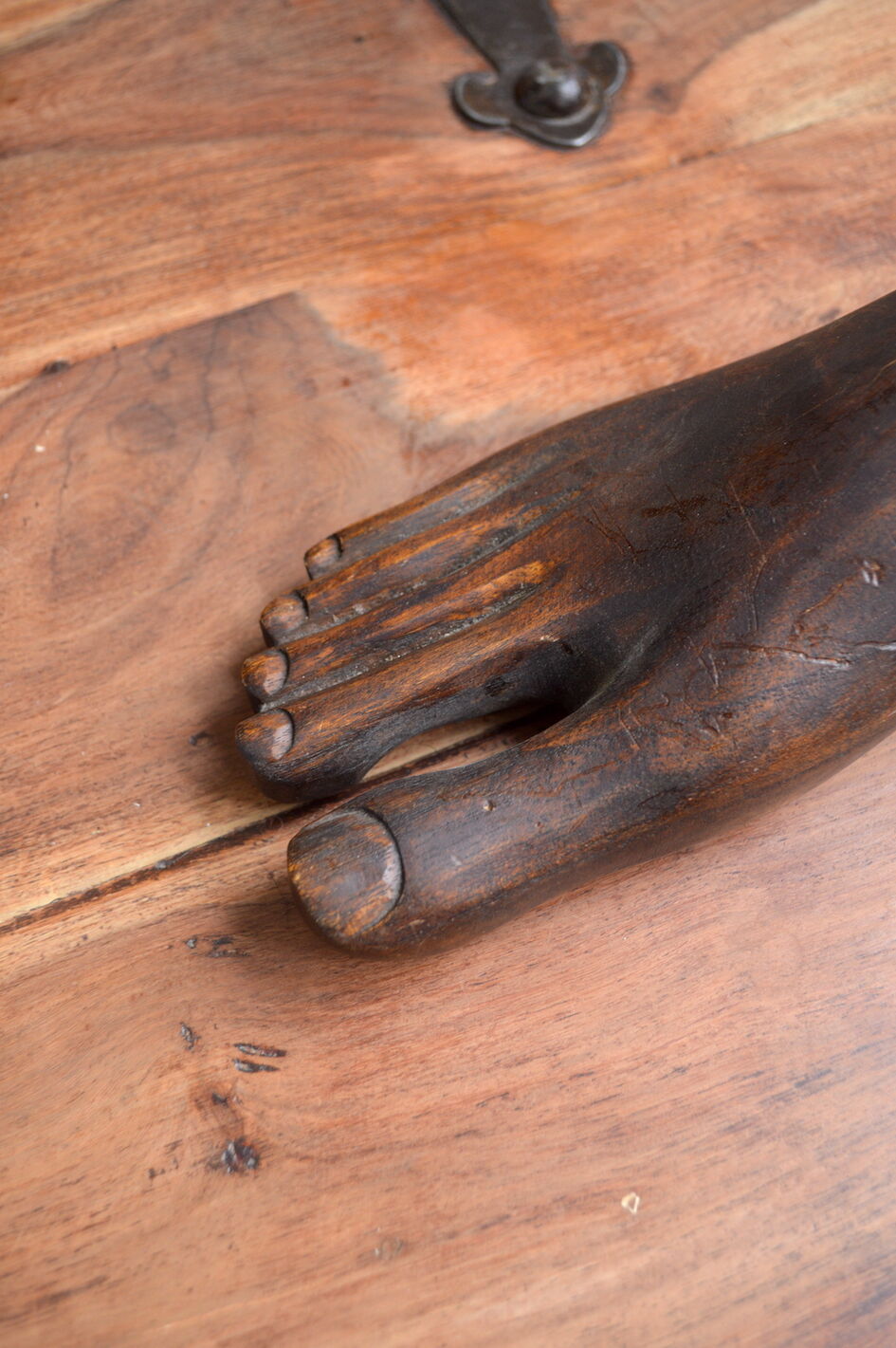 Carved wooden Buddha's foot