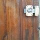 Oak entrance door and its frame and transom, wrought iron gates