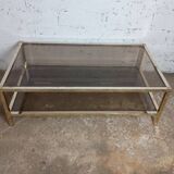 1970s coffee table in brass with a double smoked glass top.