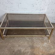 1970s coffee table in brass with a double smoked glass top.
