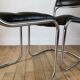 Set consisting of a table in chrome and smoked glass and its 4 tubular chairs in chrome and skaï a