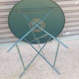 Old folding garden table in wrought iron