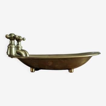 Old soap dish in the shape of a brass bathtub