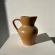 Small pitcher in light beige sandstone