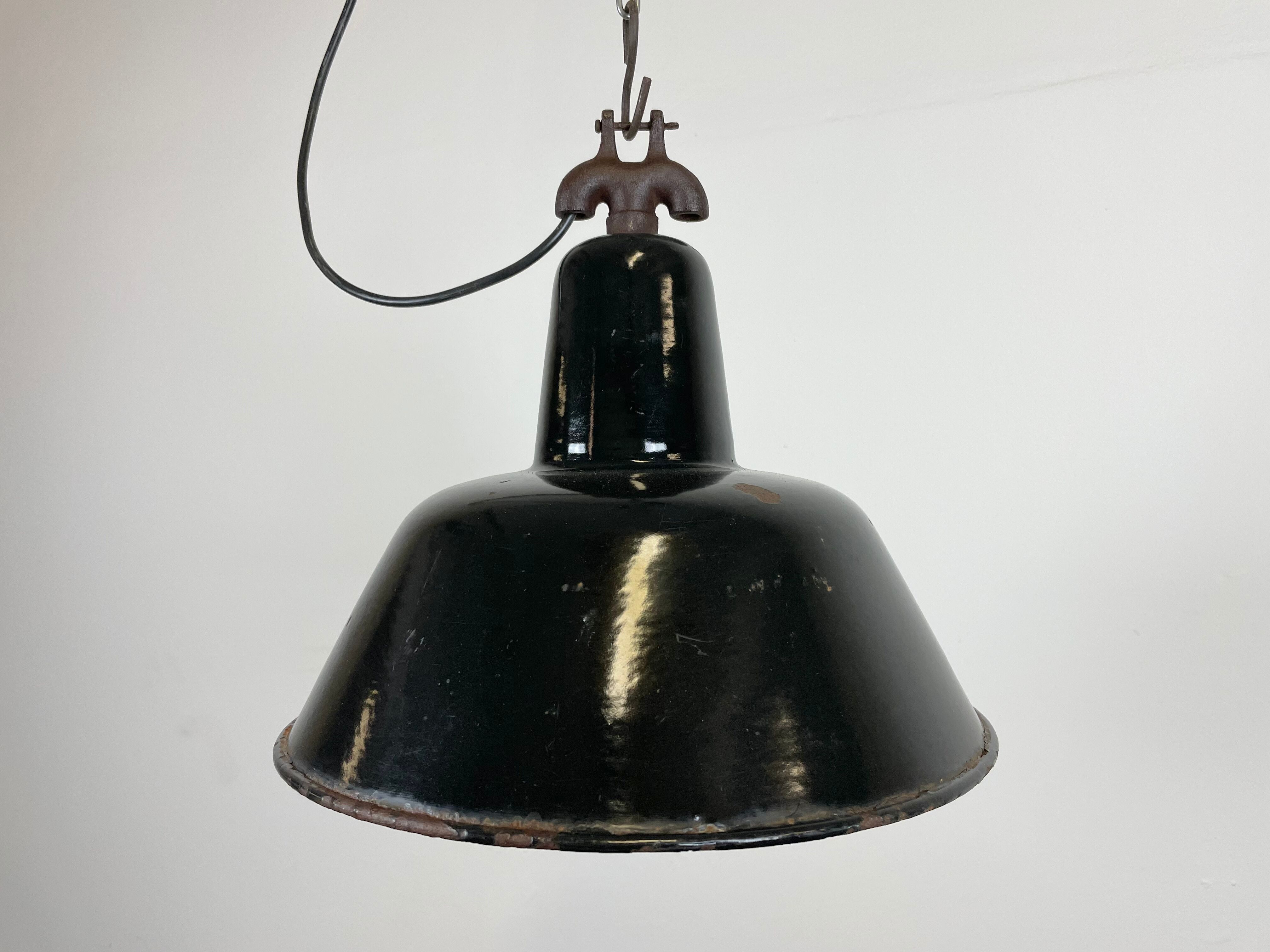 Industrial black enamel factory lamp with cast iron top, 1950s
