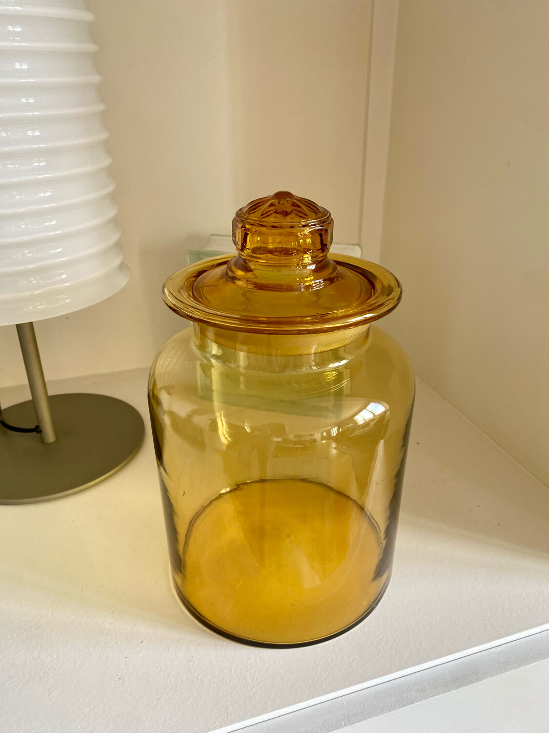 Old apothecary jar in blown amber glass