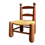 Brutalist low chair in dark wood and straw no. 3