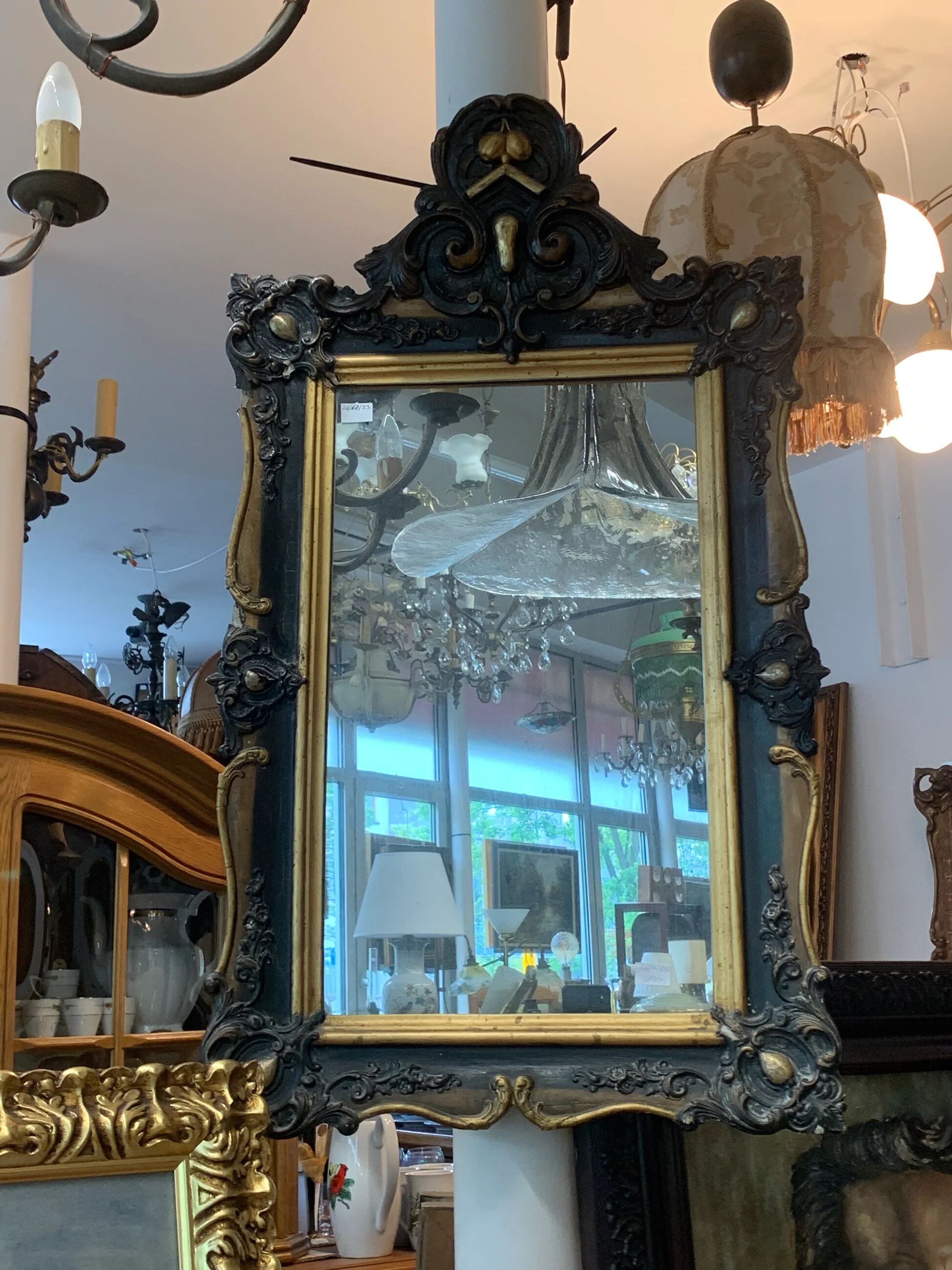 Antique bevelled mirror from the 19th century, sculpted and gilded frame.