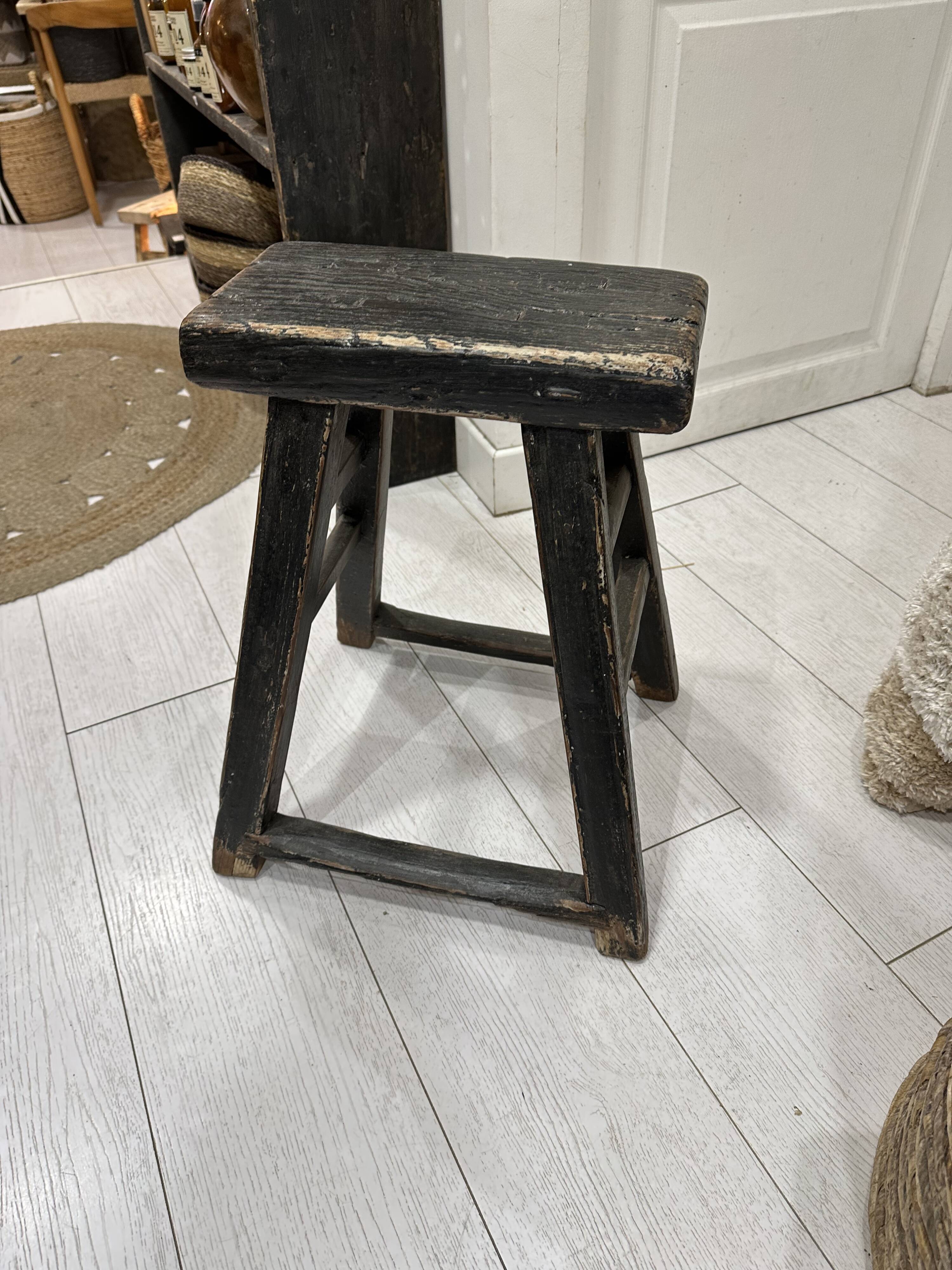 Rectangular stool in raw black elm.