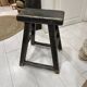 Rectangular stool in raw black elm.