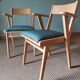Scandinavian armchairs with green tapered legs.