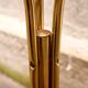 Golden pedestal table in smoked glass