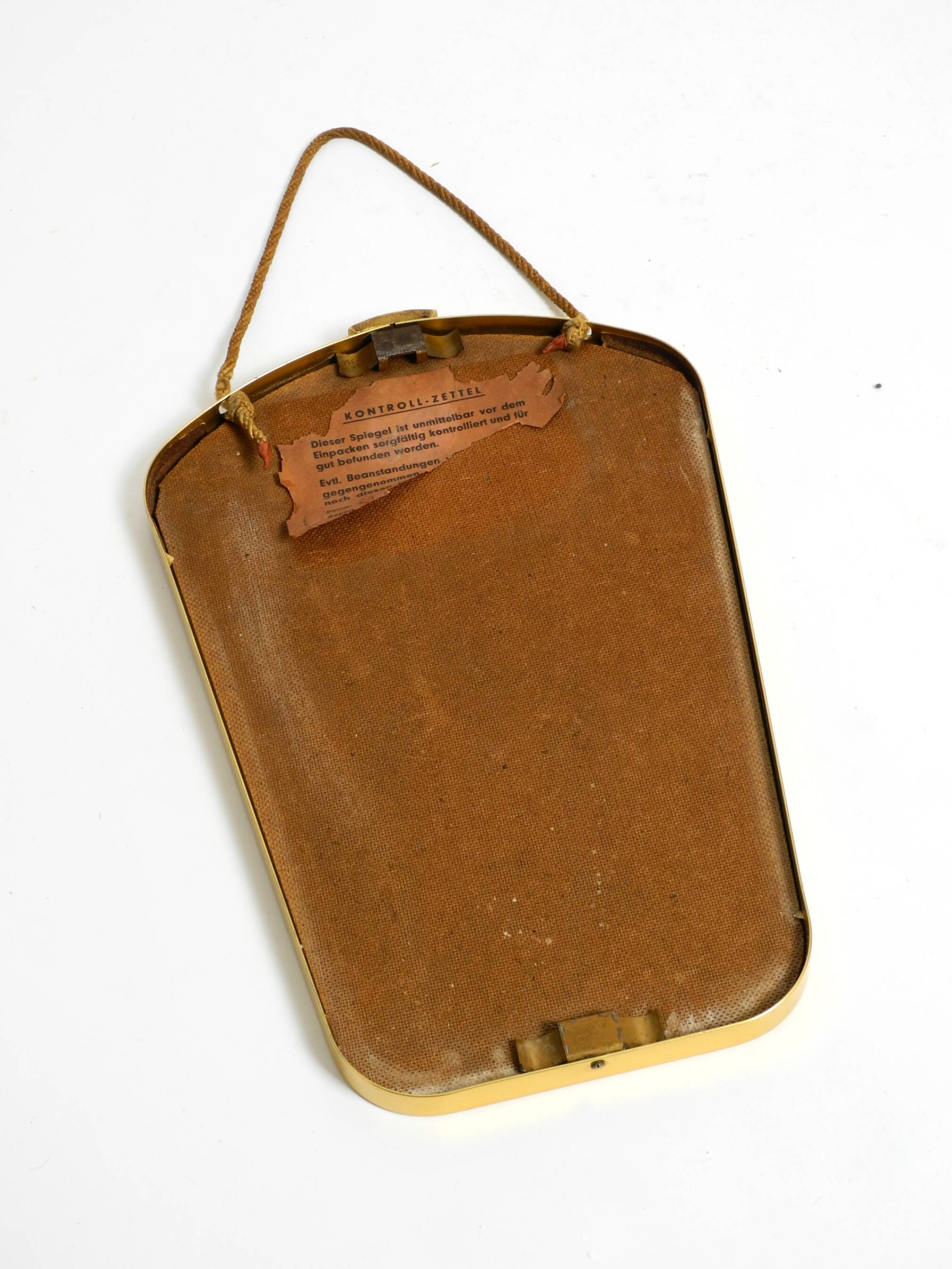 Beautiful small mid-century brass wall mirror with braided hanging strap