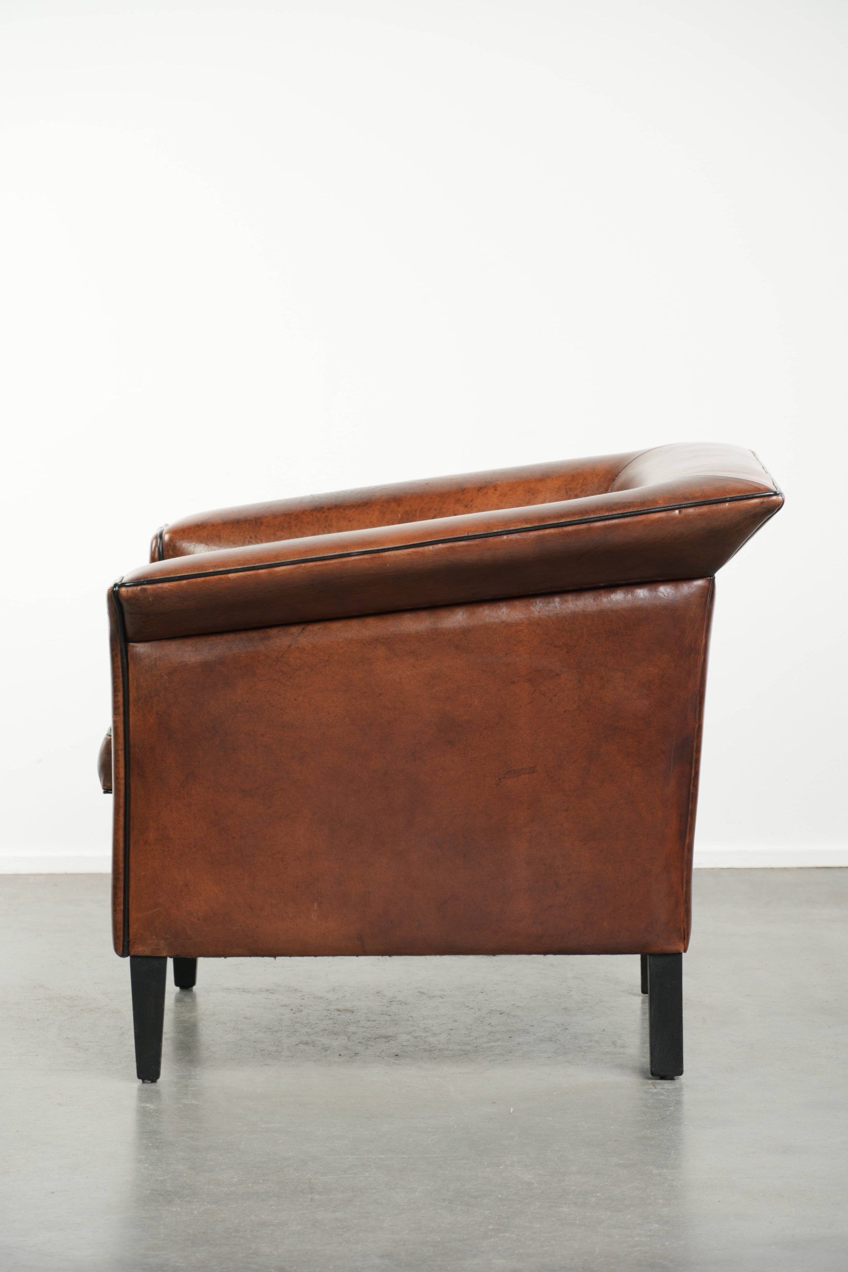 Sleek sheepskin Art Deco design armchair with black piping