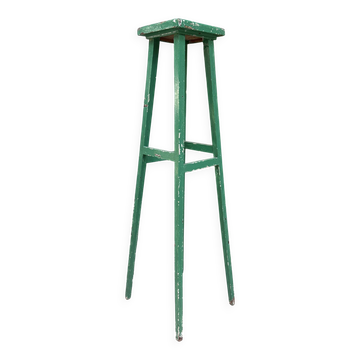 Vintage wooden stool with green patina.