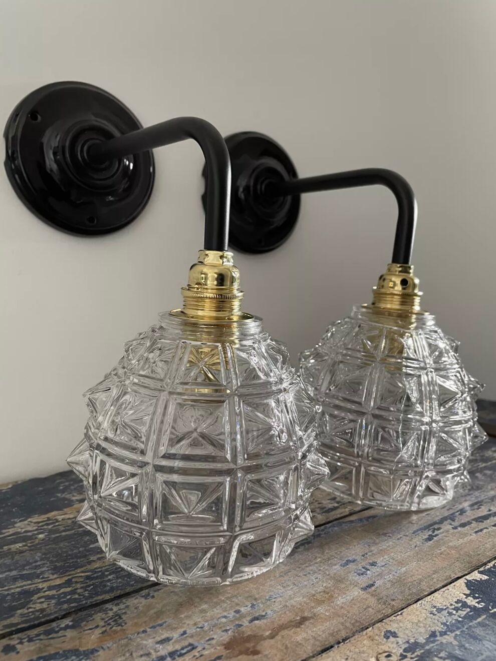 Set of two chiseled glass sconces