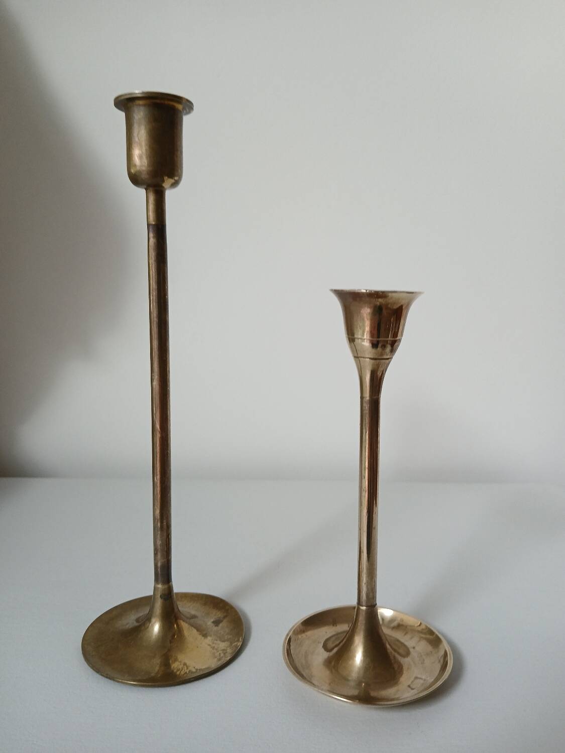 Set of two straight brass candlesticks.