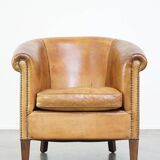 Comfortable, cozy, warm colored sheepskin club chair finished with decorative nails