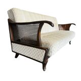 Vintage wooden armchair with rattan weaving.