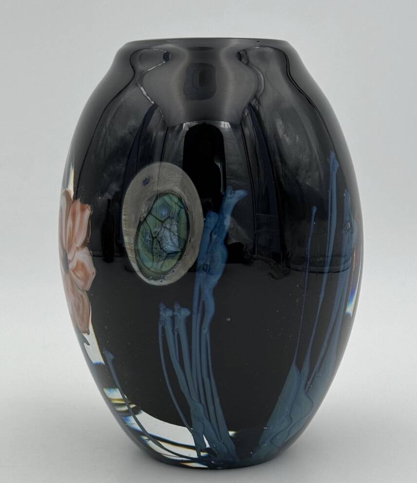 Double-lined blown glass vase with flower inclusions.