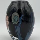 Double-lined blown glass vase with flower inclusions.