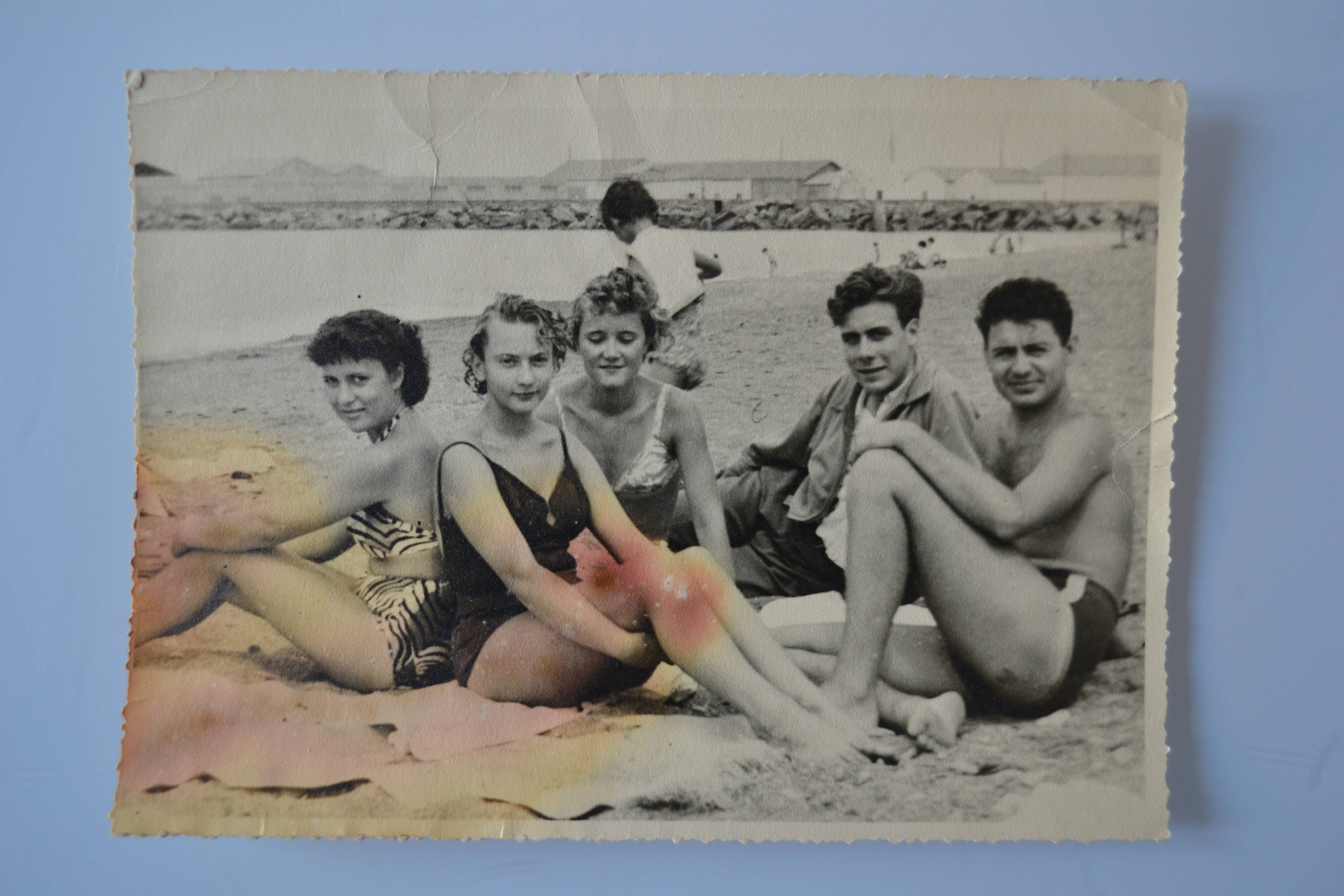 Old film photo circa 1950 the beach group of teenagers
