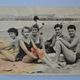 Old film photo circa 1950 the beach group of teenagers
