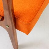 Vintage armchair in papaya orange wool from the 1960s.