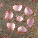Vintage red enameled cast iron trivet