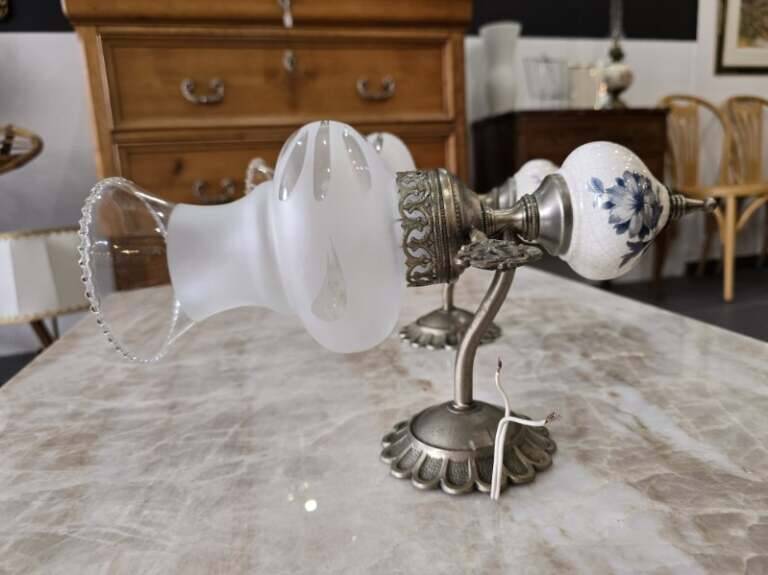 Pair of vintage wall sconces in brass, porcelain, and frosted glass.