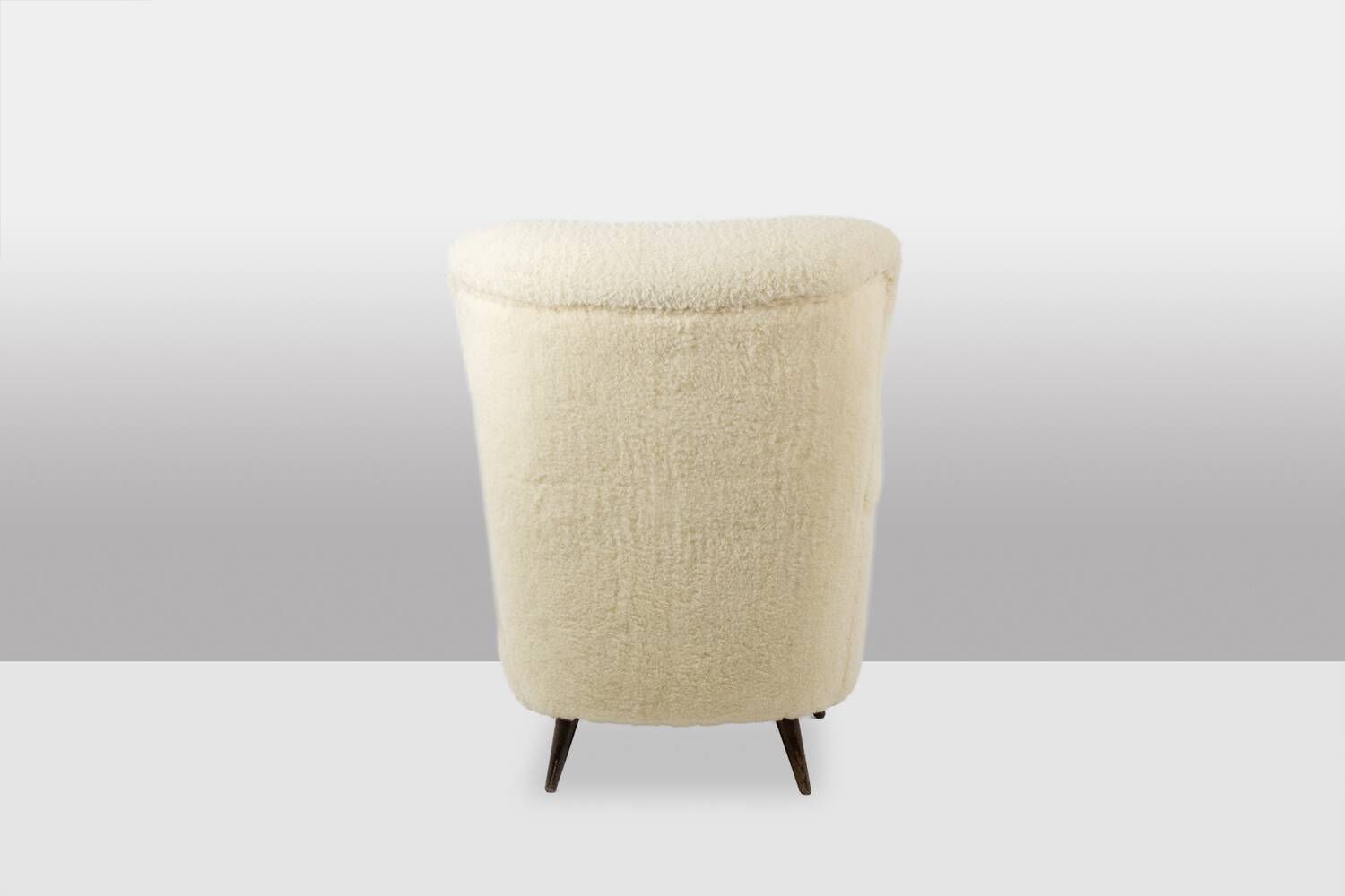 Armchair, or bergère, with its boucle fabric. 1950s