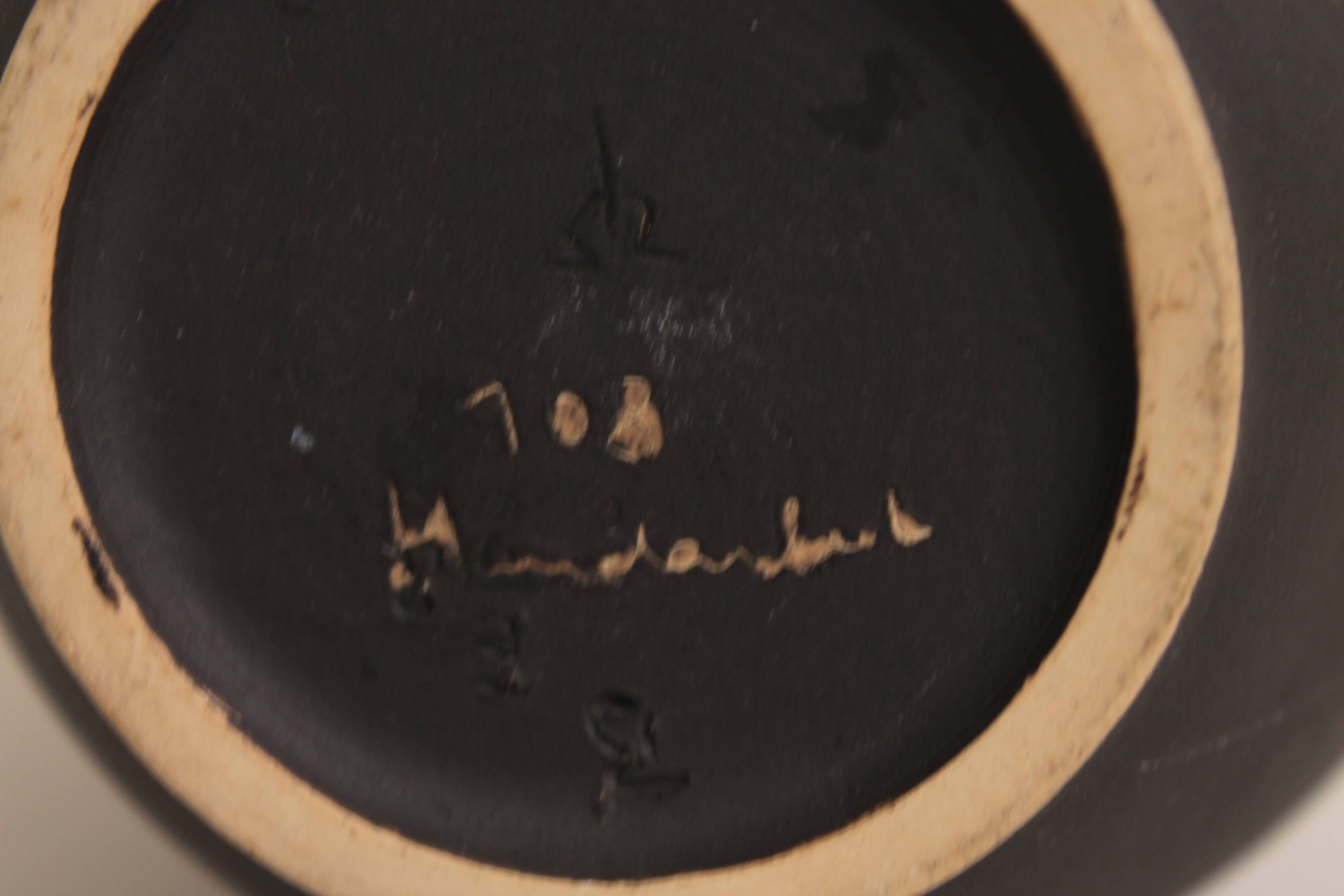 Ceramic vase decorated with women and a tree.