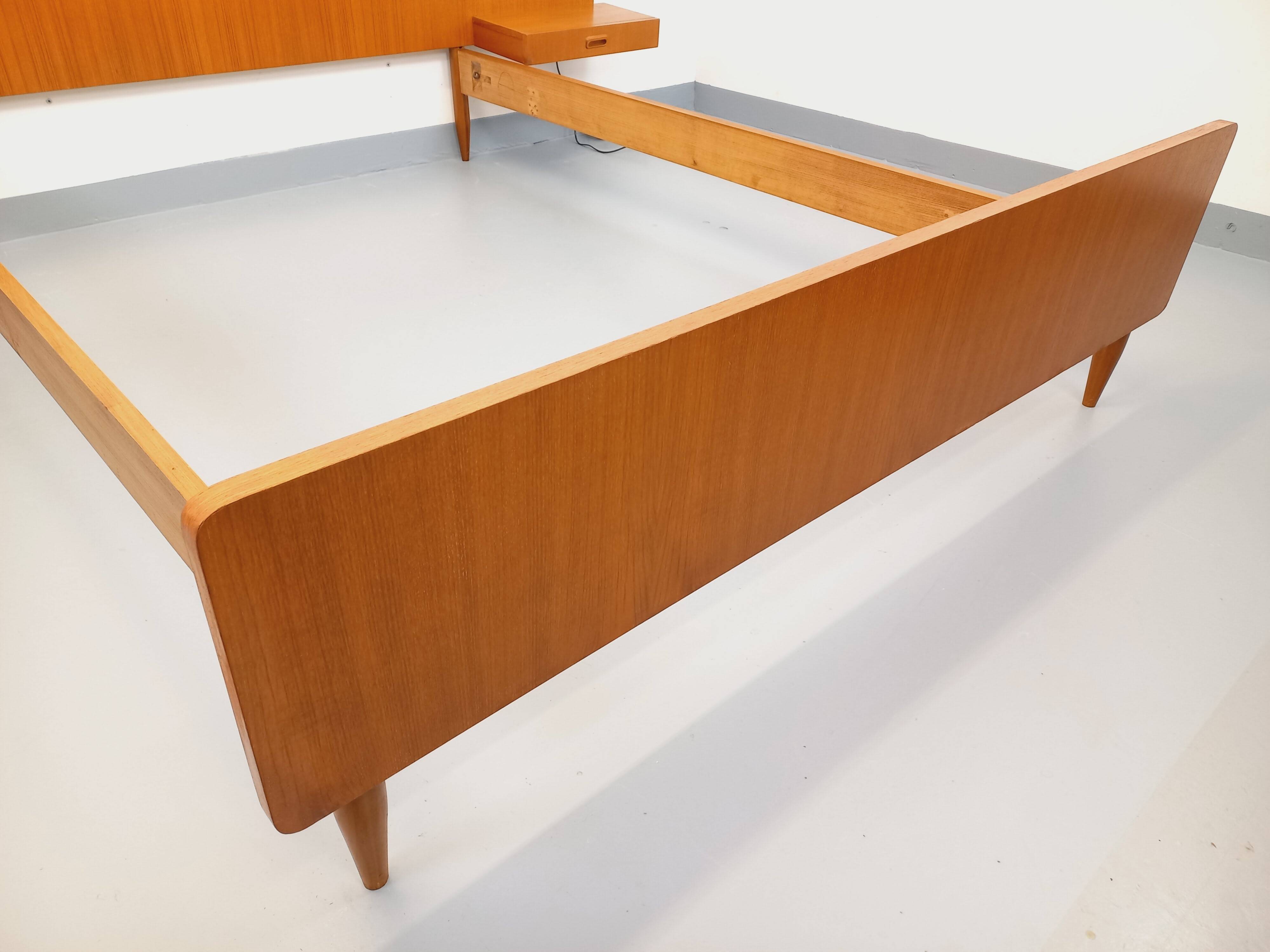 Double bed in vintage Scandinavian style from the 1960s with bedside tables.